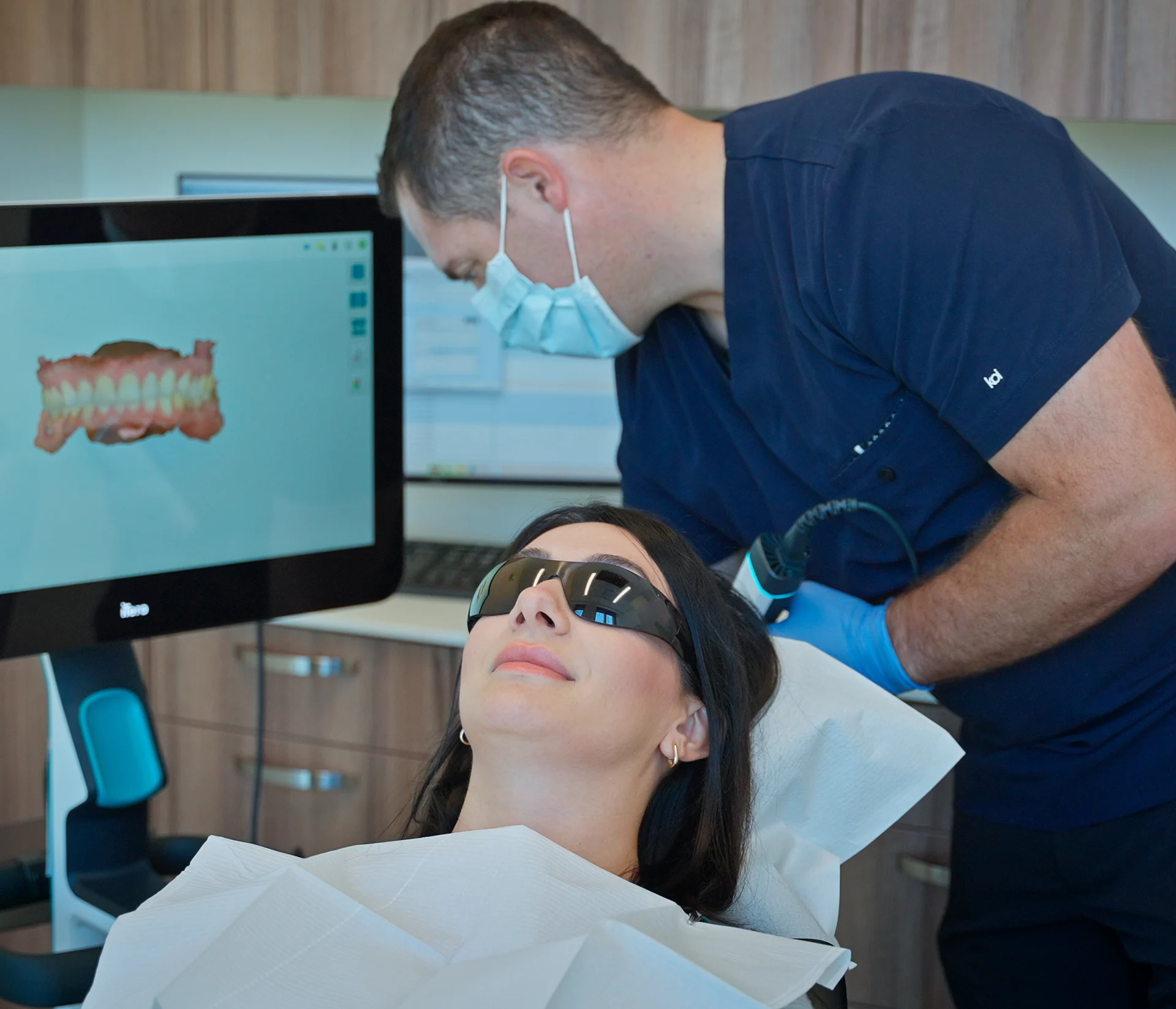 A dentist explaining treatment to a patient at Arch Dental